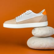Brown and off-white sneakers — left view on rocks (thumbnail)